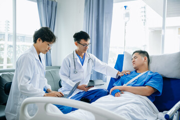Fototapeta na wymiar Hospital Ward Male and Male Professional Asian Doctors Talk with a Patient, Give Health Care Advice, Recommend Treatment Plan with Advanced Equipment