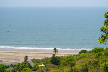 Wide angle shot of Vagator beach as seen from the top of the Chapora Fort at Goa in India. Wide angle shot of beach as seen from above. Blue sea in goa. Summer relaxation background. 