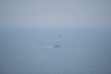 Closeup shot of boats in the Arabian sea at Goa in India. Boats as seen from the top of the hill in Goa. Fishing boats in the sea. Boats fishing in the Arabian sea.