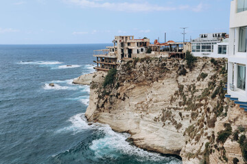 Fototapeta na wymiar Beirut, Lebanon — 24.04.2023: Abandoned restaurant on the waterfront of Beirut overlooking the famous Pigeon Rocks