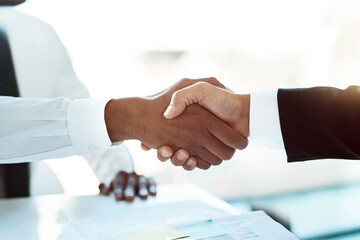 To building a better business together. Closeup shot of two unrecognizable businessmen shaking...