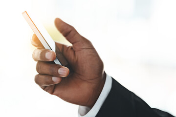 Reach out and grab success with your own hands. Closeup shot of an unrecognizable businessman using a cellphone in an office.