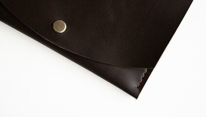 Details of man's handmade leather genuine wallet on a white surface.