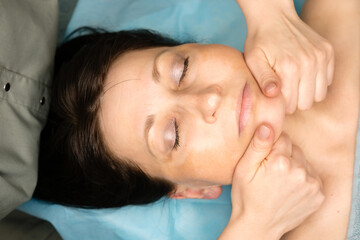 Fototapeta na wymiar Facial massage procedure at cosmetologist