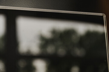 Reflective surfaces of a futuristic induction hob in black. A fuzzy, blurry photograph of a reflection in the surface of a slab.
