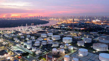 Aerial view oil and gas industry refinery at sunset, Aerial view oil and gas Industrial petrochemical fuel power and energy, Refinery factory oil storage tank and pipeline steel.