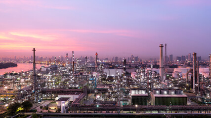 Aerial view oil and gas industry refinery at sunset, Aerial view oil and gas Industrial petrochemical fuel power and energy, Refinery factory oil storage tank and pipeline steel.