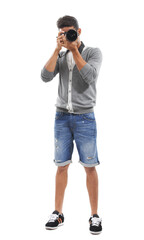 Smile for the camera. Full body shot of a young man taking a picture of you against a white...