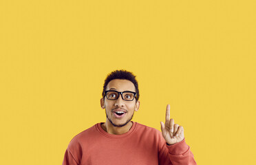 Wow, eureka. Portrait of emotional dark-skinned man who has great idea, finds inspiration or...