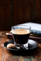 Coffee in glass cup on dark wooden background. Copy space.	