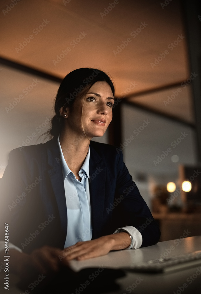 Poster Shes not afraid of a little hard work. a young businesswoman working online during a late night in a modern office.