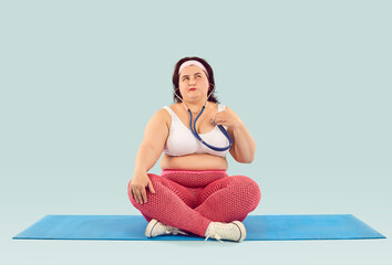 Obese woman starts worrying about health. Fat large chubby over weight girl with stethoscope sits...