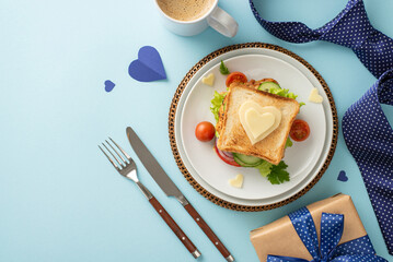 Treat Dad to a surprise breakfast on Father's Day! Top view of sandwich, cutlery, coffee cup, tie, gift box, men's accessories, on a blue background with a blank space for text