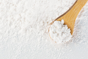 Dry tapioca starch with a wooden spoon.