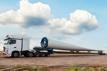 Truck on field. Blade for wind turbines. Special transport of a blade for a wind turbine on a...