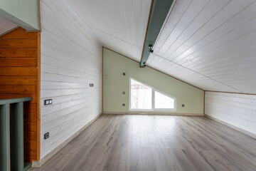 empty room without furniture in green tones in the attic