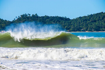 Perfect wave breaking with a beautiful Island behind. 