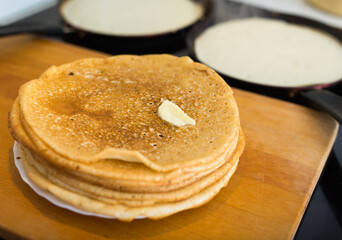 cooking traditional pancakes from wheat flour in the kitchen