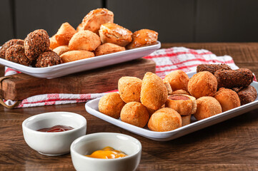Various brazilian snacks deep fried. (Coxinha, kibe, empadinha e risolis).