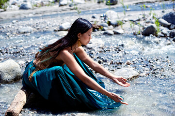 Photograph of a beautiful woman in a flowing river.  - 599262843