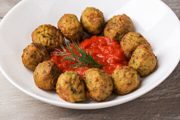 Atlantic salmon meatballs with spinach served with tomato sauce