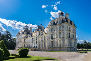 Cheverney castle in the Loire Valley, France, with blue sky dotted with small white clouds