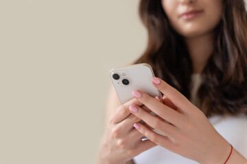 Young woman hands using smartphone close up. Teenage girl scrolling, watching video
