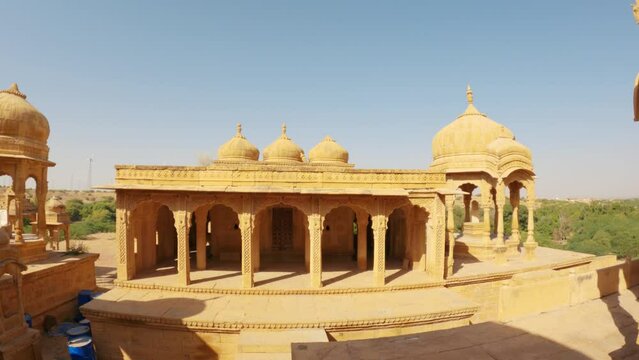 4K Wide angle shot of dome shaped cenotaphs of old Kings at Bada bagh in Jaisalmer, Rajasthan, India. Old tombs of the ancient kings in Jaisalmer made out of sand stone. Bada bagh during sunny day .