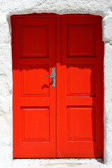 old red door next to white wall