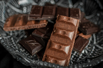 several types of chocolate bars on a light background