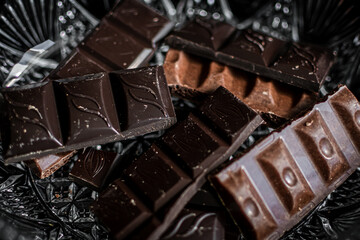 several types of chocolate bars on a light background
