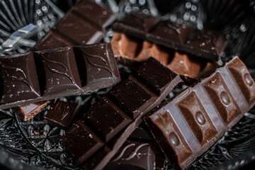 several types of chocolate bars on a light background
