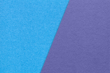 Texture of craft blue and violet paper background, half two colors, macro. Vintage turquoise and very peri cardboard.