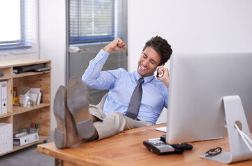 Awesome news. a handsome young businessman looking excited in the office.