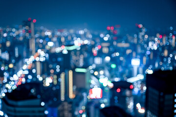 大都会の輝く夜景をぼかした背景素材