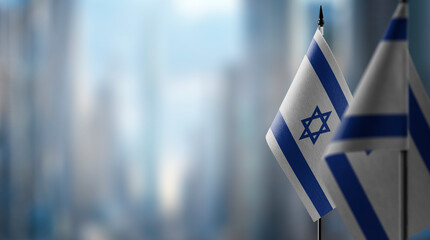 Small flags of the Israel on an abstract blurry background