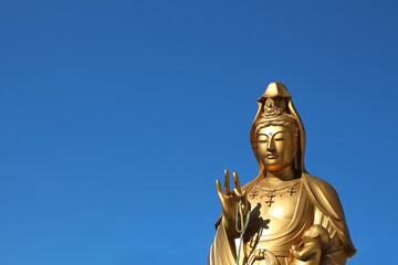 Fototapeta na wymiar Jibo Kannon Golden Statue nearby Fushimi Inari, Buddhist Goddess of Mercy, Buddha isolated sculpture
