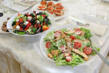 Caesar and Greek salads on the festive table