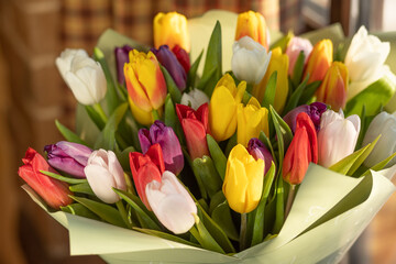 A tulip, a bouquet of colorful tulips. A gift for March 8, International Women's Day. Festive decor with flowers. Bouquet with colorful tulips.