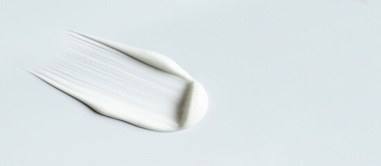 cosmetic smears of creamy texture on gray background