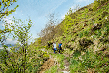 Young couple in sportswear doing a breack during a hike near Holzarté in the French Basque Country