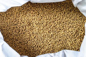 Feed for livestock. Rich nutritional Pellet animal feed on white background. A bag. Large granules...