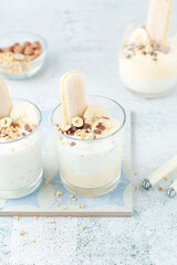 Milk mousse dessert with nuts in glasses	