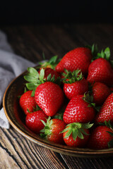 A bowl with ripe bright strawberry in rustic style	