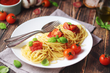 Italian pasta spaghetti with basil and cherry tomatoes	