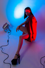 
fashion shoot girl in neon light and red jacket