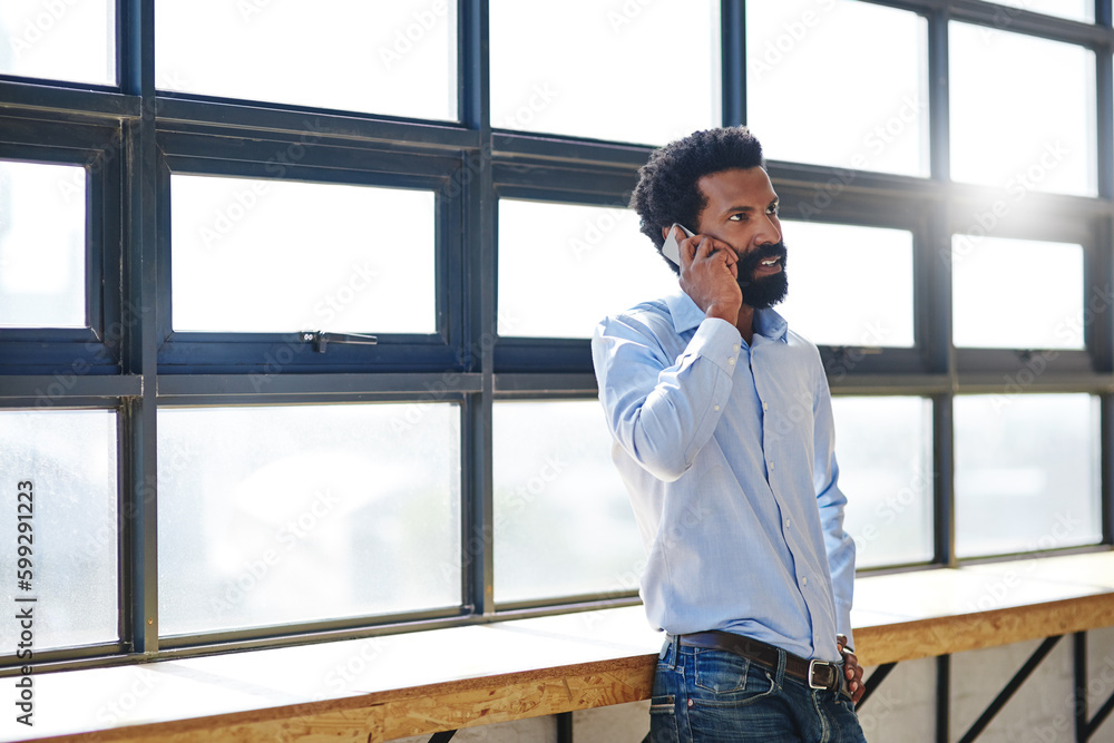 Poster explain it to me...a businessman talking on his cellphone in an office.