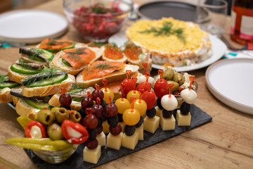light snacks on the festive table, canapes, sandwiches with fish, 