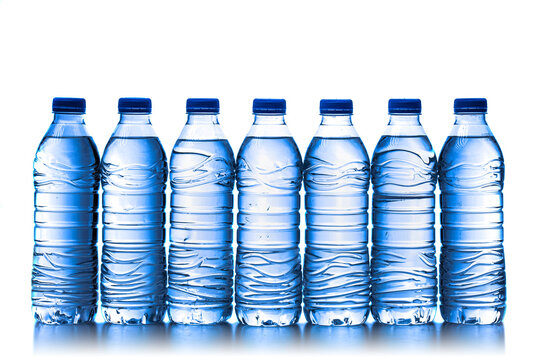 pile of half litre plastic water bottles with blue cap