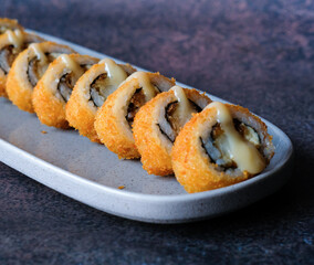 Assorted Sushi, Maki, rolls, nigiri, uramaki, hosomaki, a variety of Japanese sushi, Sushi Set sashimi and sushi rolls, long plate, fine dining, rice, fish, on a dark background, smoked eel, Japan